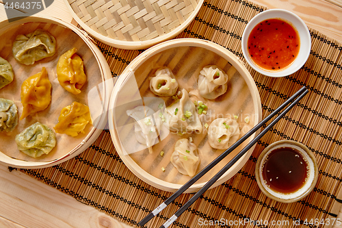 Image of Oriental traditional chinese dumplings served in the wooden steamer