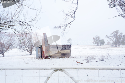 Image of Ramshackle rustic shack in snowy rural scene