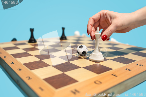 Image of soccer ball of chess pieces on the board
