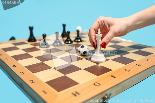Image of soccer ball of chess pieces on the board