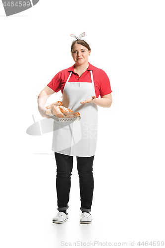 Image of Portrait of cute smiling woman with pastries in her hands in the studio, isolated on white background