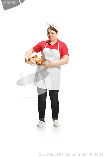 Image of Portrait of cute smiling woman with pastries in her hands in the studio, isolated on white background