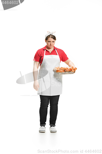 Image of Portrait of cute smiling woman with pastries in her hands in the studio, isolated on white background