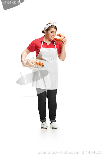 Image of Portrait of cute smiling woman with pastries in her hands in the studio, isolated on white background