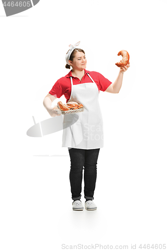 Image of Portrait of cute smiling woman with pastries in her hands in the studio, isolated on white background