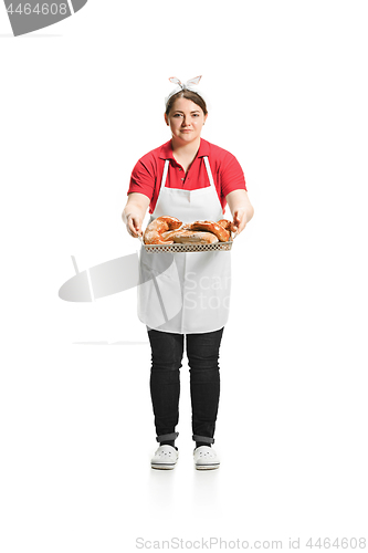 Image of Portrait of cute smiling woman with pastries in her hands in the studio, isolated on white background