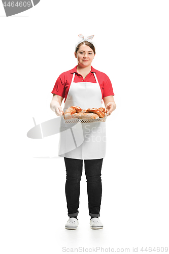 Image of Portrait of cute smiling woman with pastries in her hands in the studio, isolated on white background