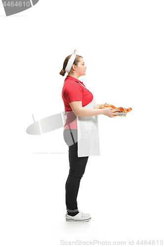 Image of Portrait of cute smiling woman with pastries in her hands in the studio, isolated on white background