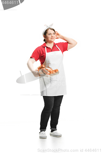 Image of Portrait of cute smiling woman with pastries in her hands in the studio, isolated on white background