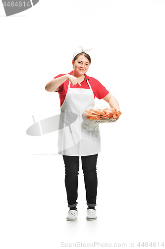 Image of Portrait of cute smiling woman with pastries in her hands in the studio, isolated on white background