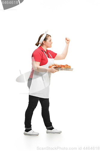 Image of Portrait of cute smiling woman with pastries in her hands in the studio, isolated on white background