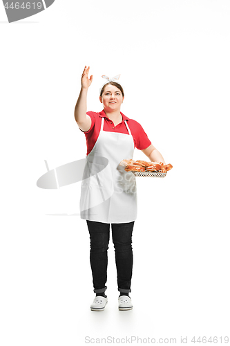 Image of Portrait of cute smiling woman with pastries in her hands in the studio, isolated on white background