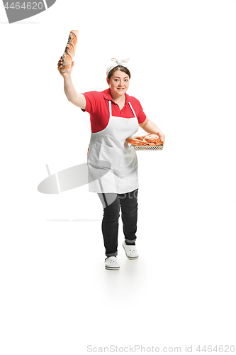 Image of Portrait of cute smiling woman with pastries in her hands in the studio, isolated on white background