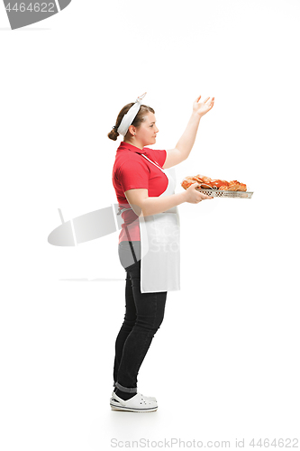 Image of Portrait of cute smiling woman with pastries in her hands in the studio, isolated on white background