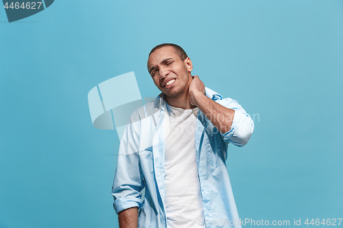 Image of Young man overwhelmed with a pain in the neck