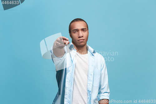 Image of The overbearing businessman point you and want you, half length closeup portrait on blue background.