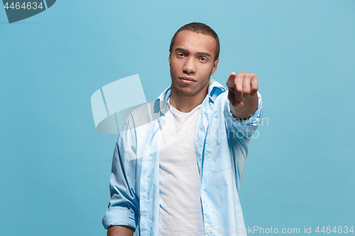 Image of The overbearing businessman point you and want you, half length closeup portrait on blue background.