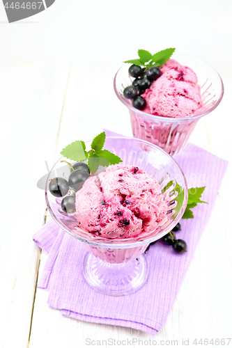 Image of Ice cream with black currant in two glasses on napkin