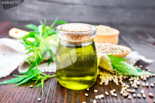 Image of Oil hemp in jar with flour and grain on board