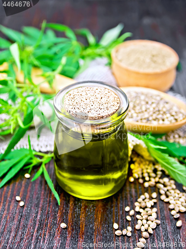 Image of Oil hemp in jar with flour and grain on dark board