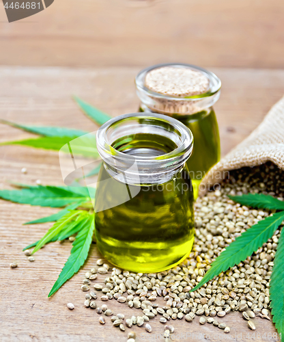 Image of Oil hemp in two jars with sheet on old board