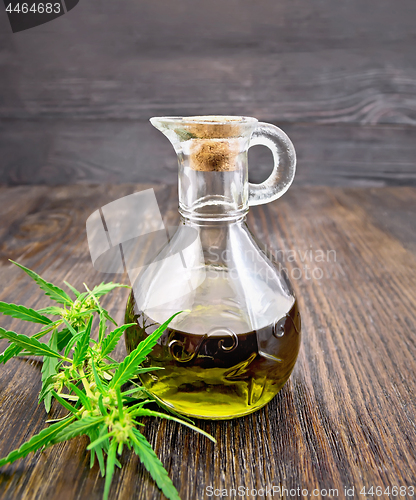 Image of Oil hemp in glass decanter on dark board