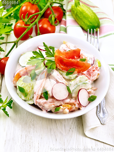 Image of Salad from fresh vegetables in plate on light board