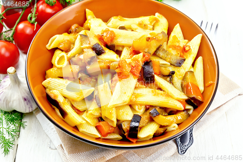 Image of Pasta penne with eggplant and tomatoes on kitchen towel