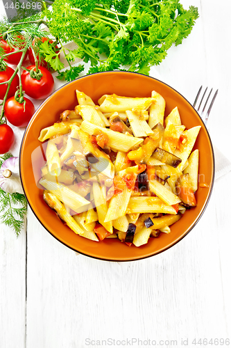 Image of Pasta penne with eggplant and tomatoes on board top