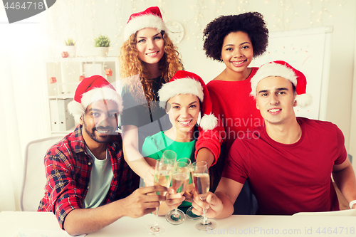 Image of happy team celebrating christmas at office party