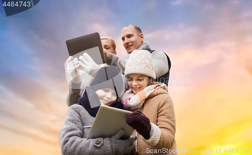 Image of family with tablet pc computers over sky