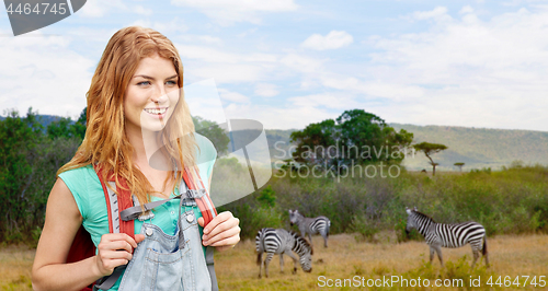 Image of happy woman with backpack over african savannah