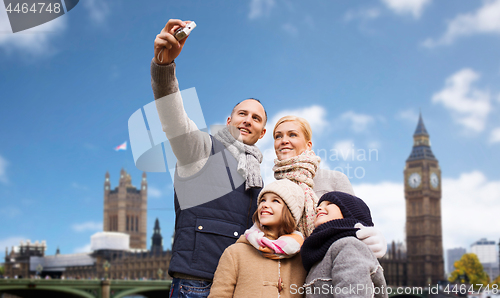 Image of family taking selfie by camera over london city