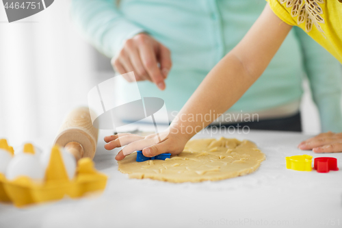 Image of mother and daughter making cookies at home