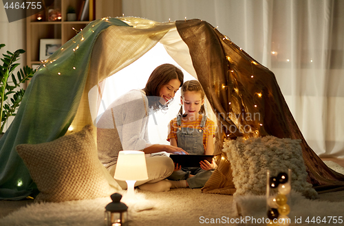 Image of family with tablet pc in kids tent at home