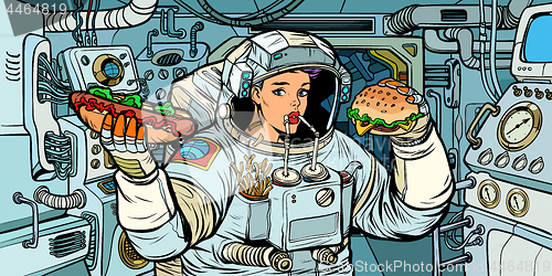 Image of Woman astronaut eats in a spaceship