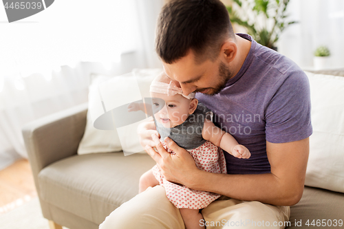 Image of close up of father with little baby girl at home