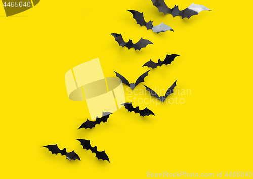 Image of black halloween bats on yellow background