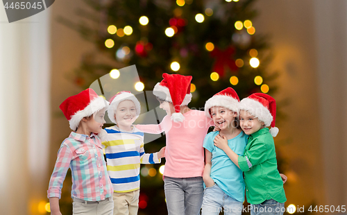 Image of happy children over christmas tree lights