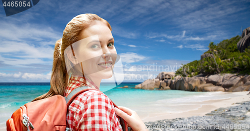 Image of happy woman with backpack over seychelles beach