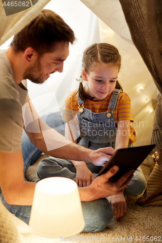 Image of family with tablet pc in kids tent at home