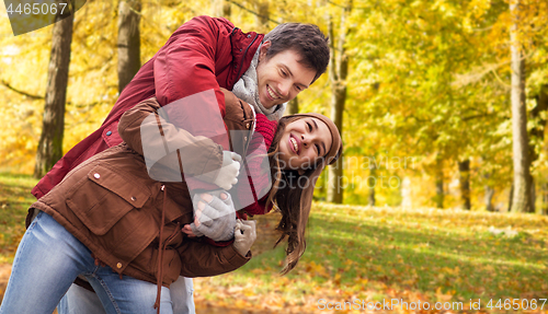 Image of happy young couple having fun in autumn park