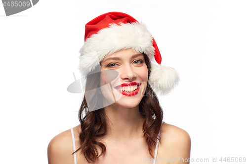 Image of woman with red lipstick in santa hat at christmas
