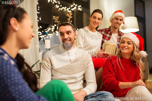 Image of friends celebrating christmas at home party