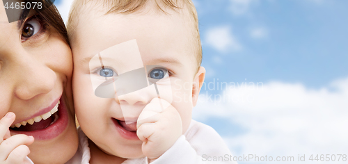 Image of mother with baby over sky background