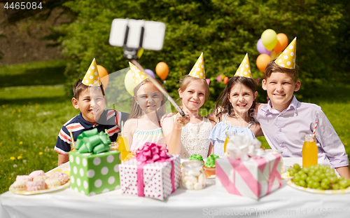 Image of happy kids taking selfie on birthday party