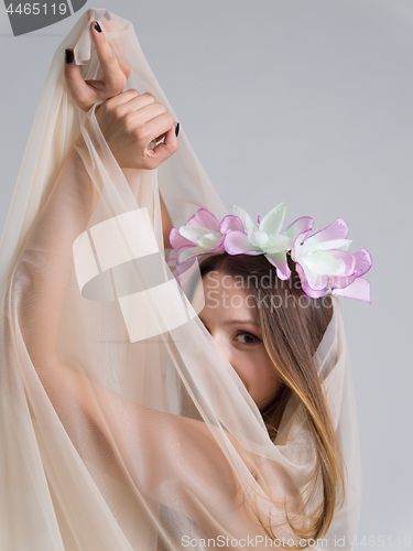 Image of young bride in a wedding dress with a veil