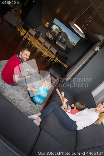 Image of Happy family playing a third-person video game