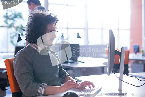 Image of businessman working using a computer in startup office