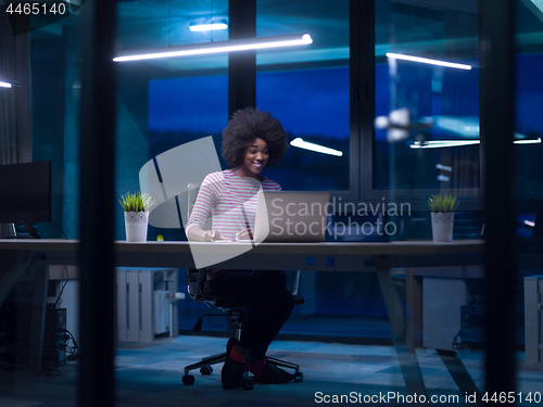 Image of black businesswoman using a laptop in startup office